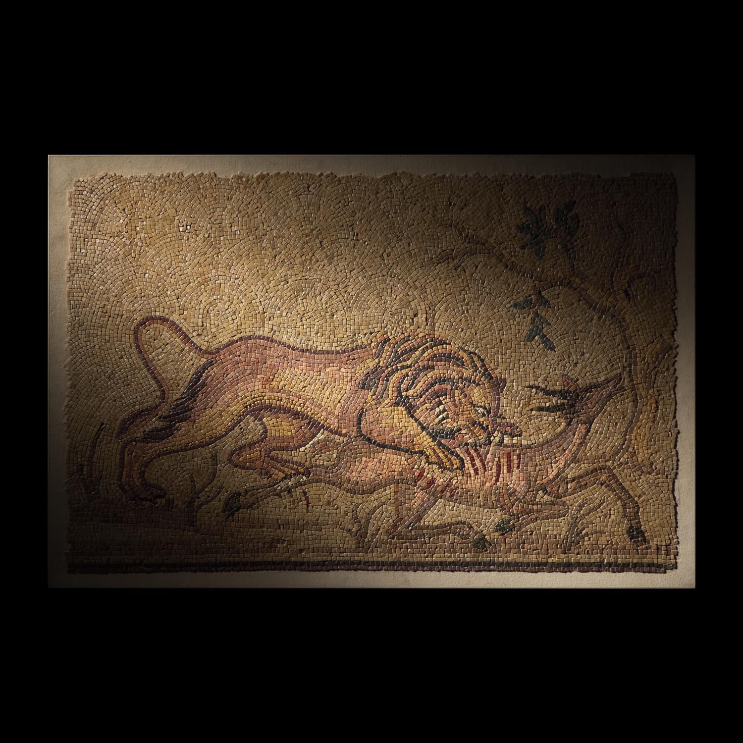 A Roman Style Stone Mosaic Panel with a Lion Hunting Prey
