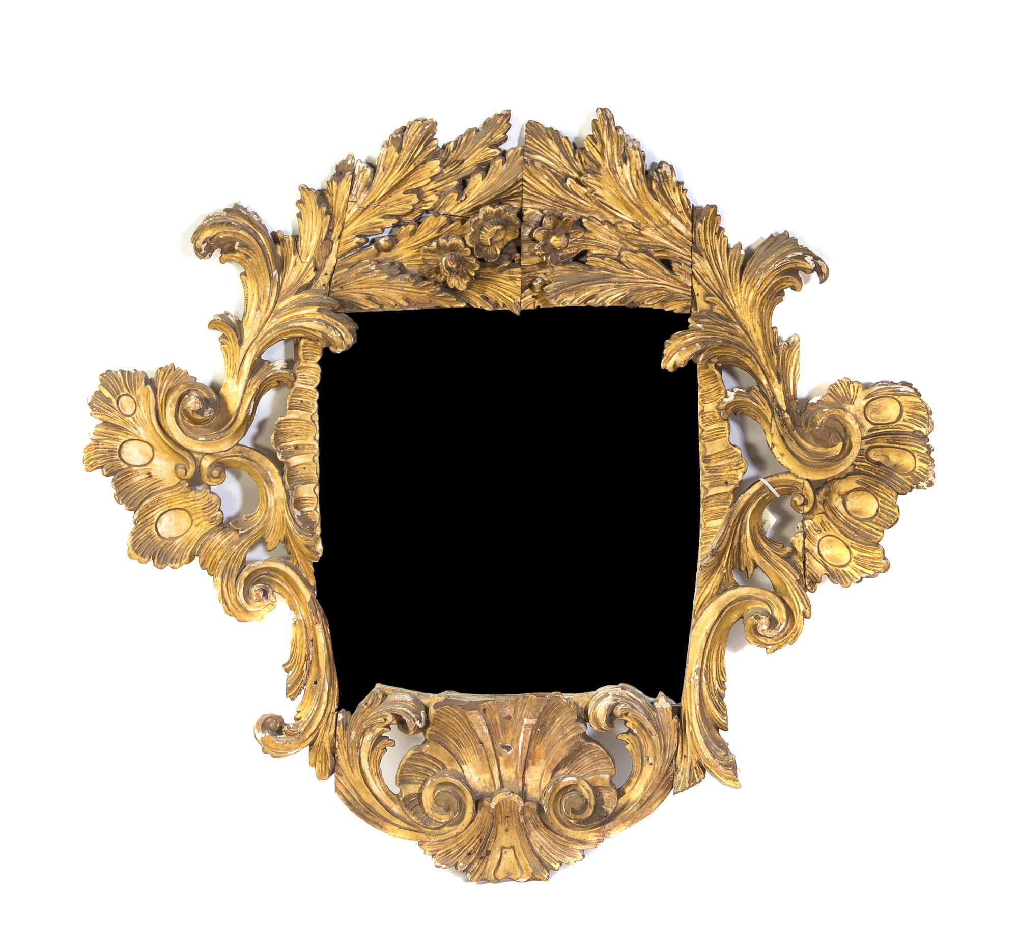 An Italian Baroque Giltwood Mirror, Height 51 1/2 x width 57 1/2 inches.