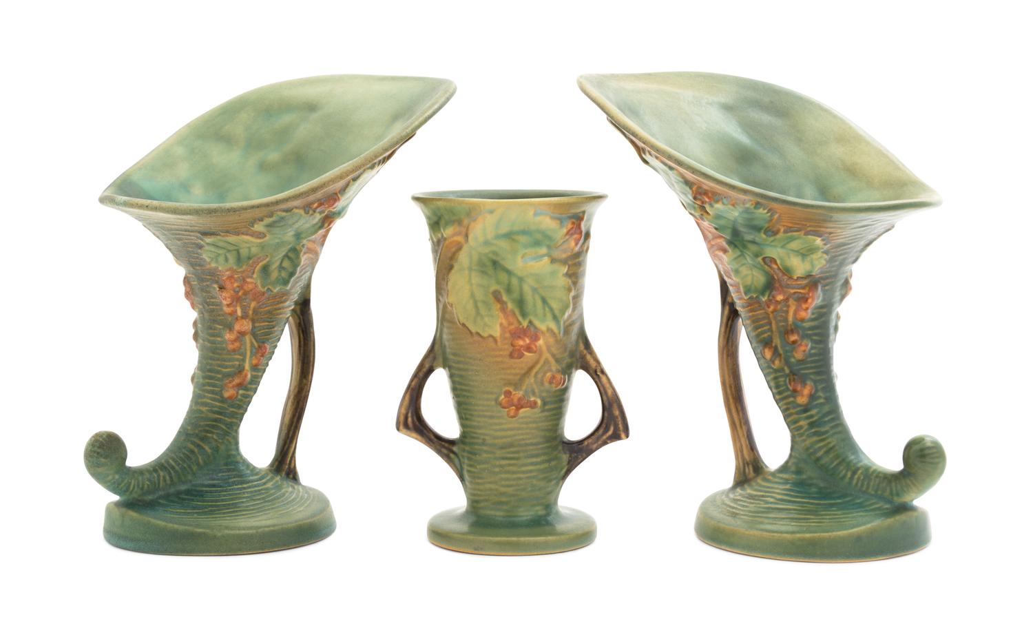 Three Roseville Bushberry Pottery Vases Height of pair 8 1/4 inches, single 9 1/4 inches.