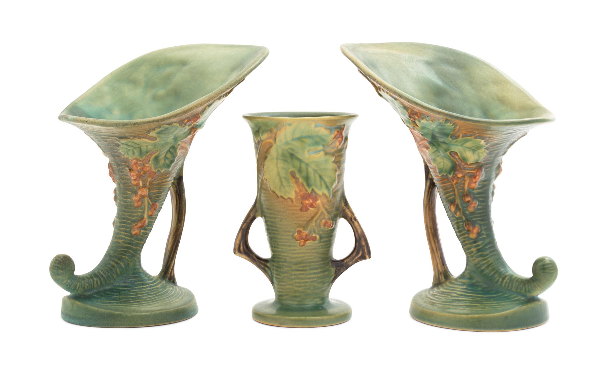 Three Roseville Bushberry Pottery Vases Height of pair 8 1/4 inches, single 9 1/4 inches.