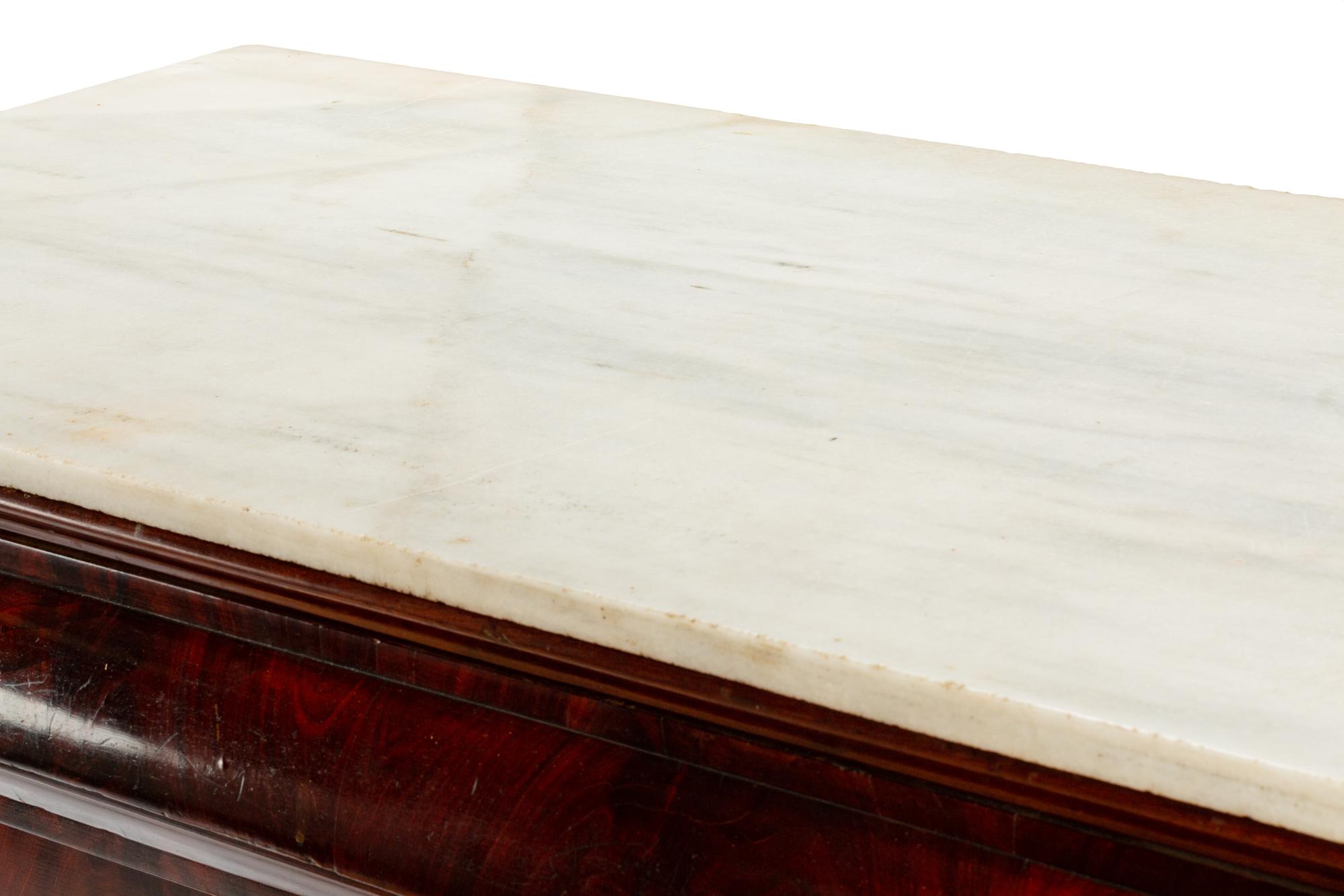 An Italian Parcel Gilt Mahogany Marble-Top Commode