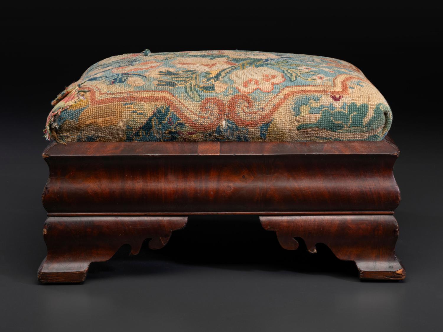 An American Empire Mahogany Veneered and Needlepoint Upholstered Footstool