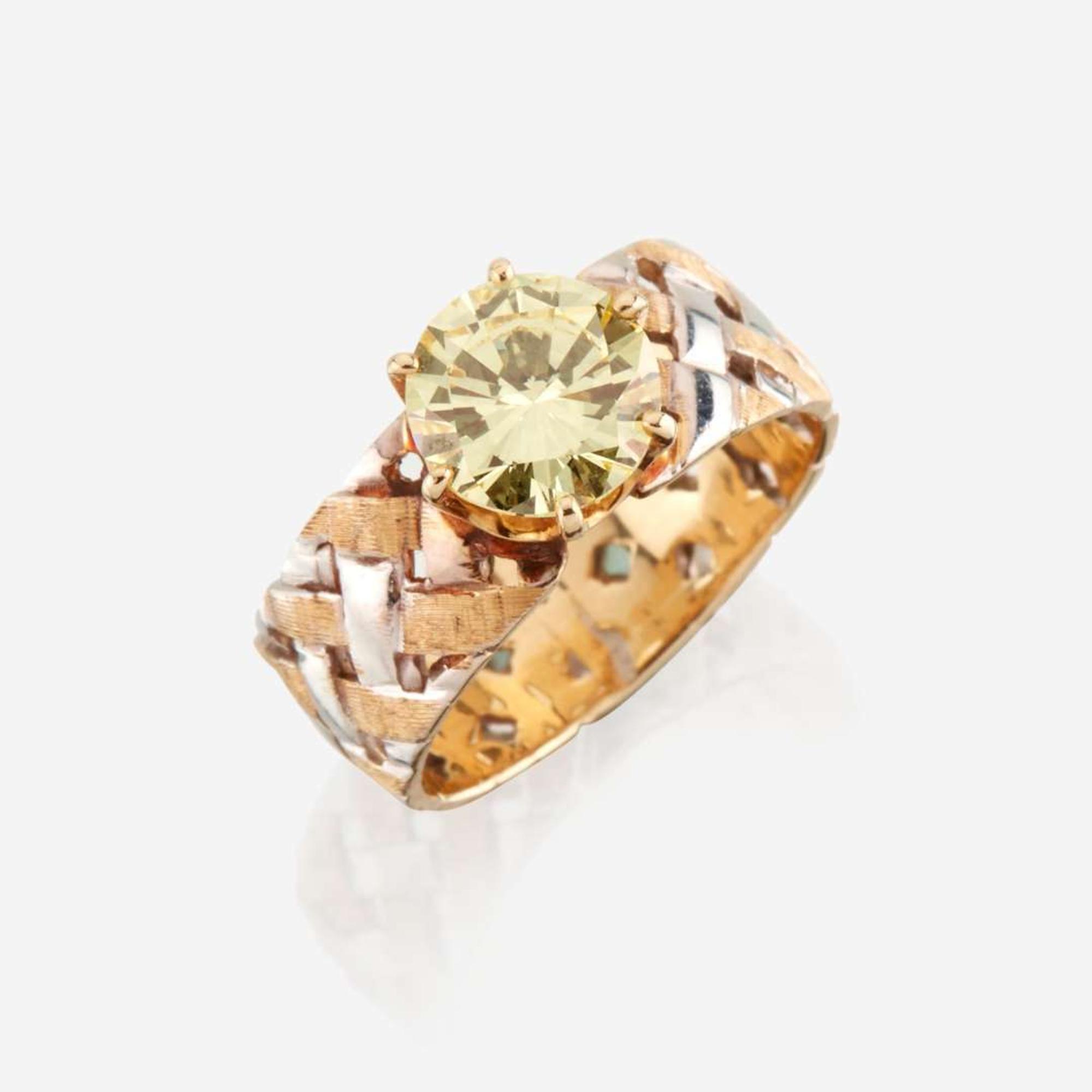 A colored diamond and bicolor gold ring