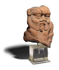 An Egyptian Terracotta Head of Bes