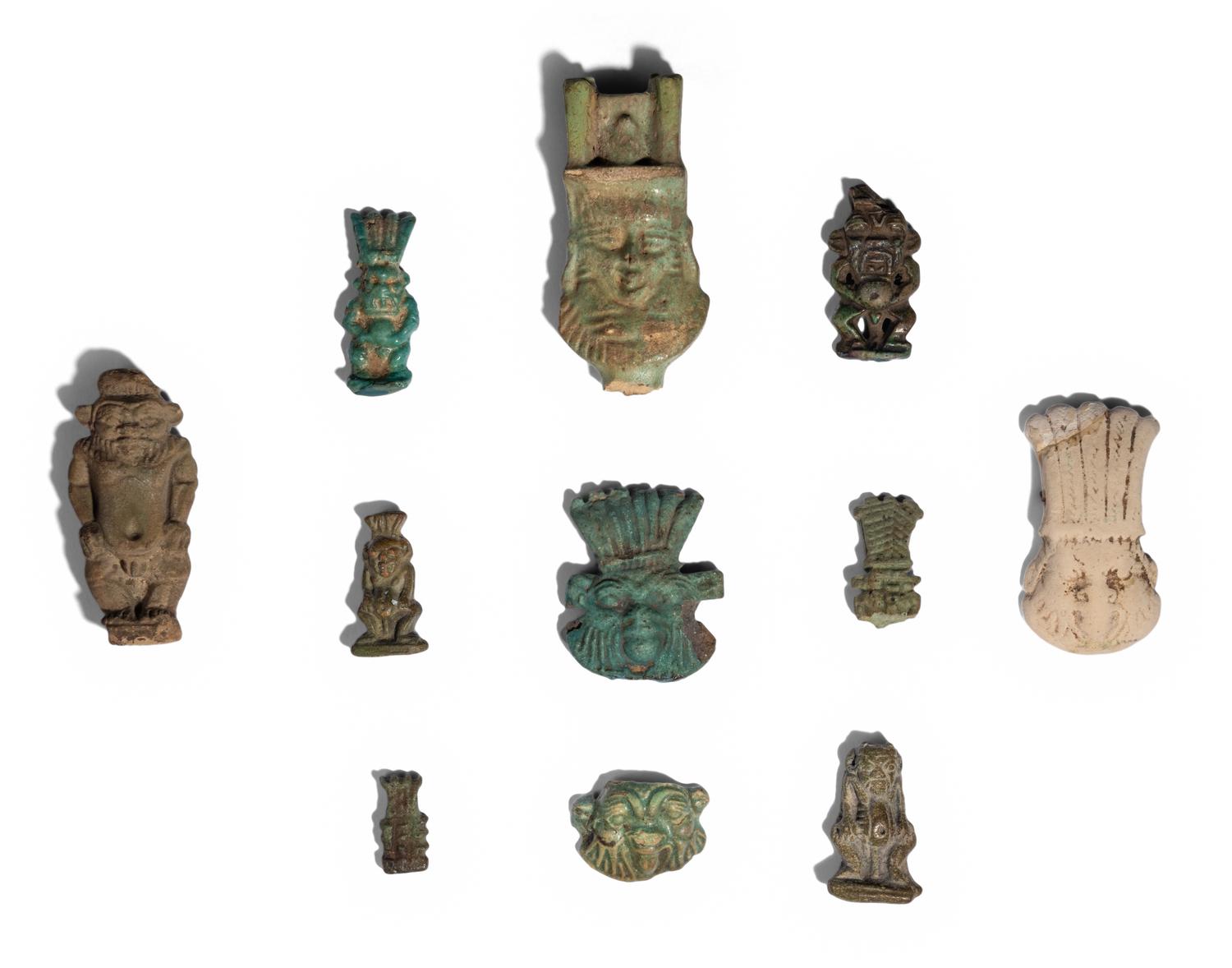 Eleven Egyptian Faience and Terracotta Bes Figures and Amulets