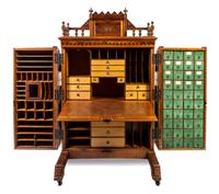 A Wooton Walnut Patent Secretary Desk Height of desk 70 1/2 x width 42 1/2 x depth 31 1/2 inches. — LATE 19TH CENTURY