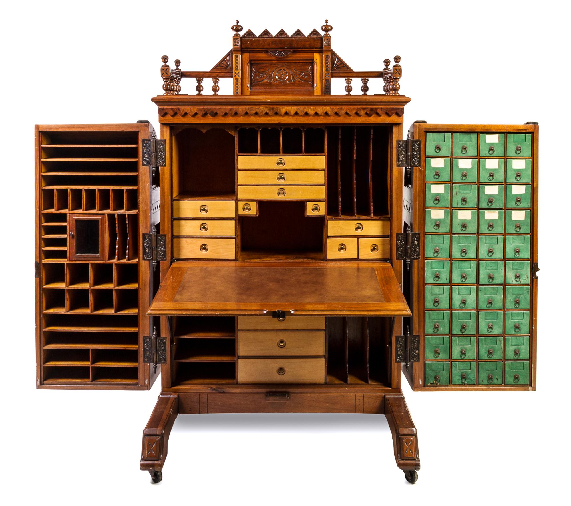 A Wooton Walnut Patent Secretary Desk Height of desk 70 1/2 x width 42 1/2 x depth 31 1/2 inches. — LATE 19TH CENTURY