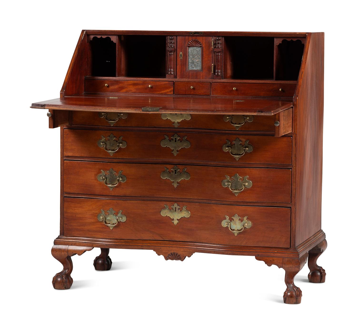 A Chippendale Carved and Figured Mahogany Reverse-Serpentine Claw-and-Ball Foot Slant-Front Desk