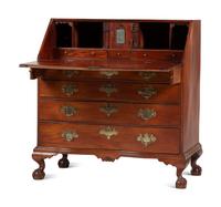 A Chippendale Carved and Figured Mahogany Reverse-Serpentine Claw-and-Ball Foot Slant-Front Desk