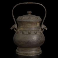 A Chinese patinated bronze archaistic vessel and cover, you 复古风格铜提梁卣