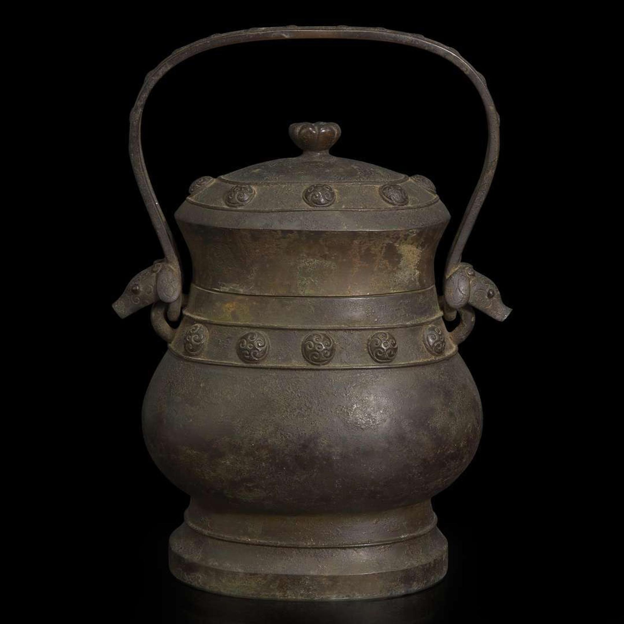 A Chinese patinated bronze archaistic vessel and cover, you 复古风格铜提梁卣