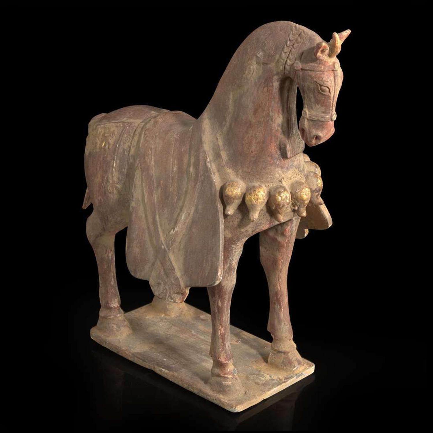 A Chinese painted and parcel-gilt pottery figure of a caparisoned horse 彩绘漆金陶马 Northern Wei dynasty ??