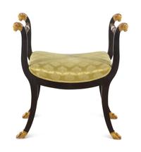 An Italian Parcel Gilt and Ebonized Curule Bench