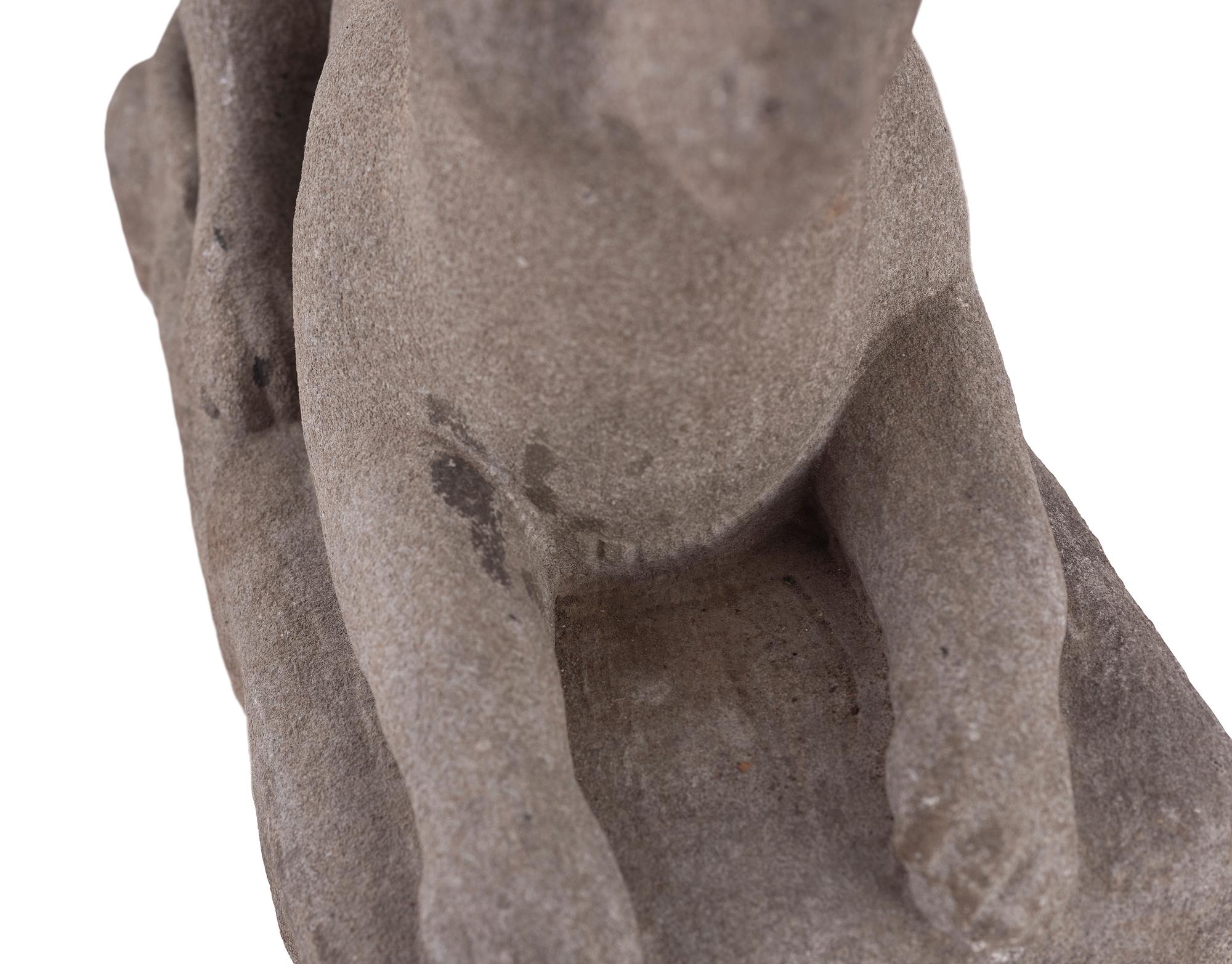 A Carved Stone Recumbent Dog, In the Manner of Edmondson