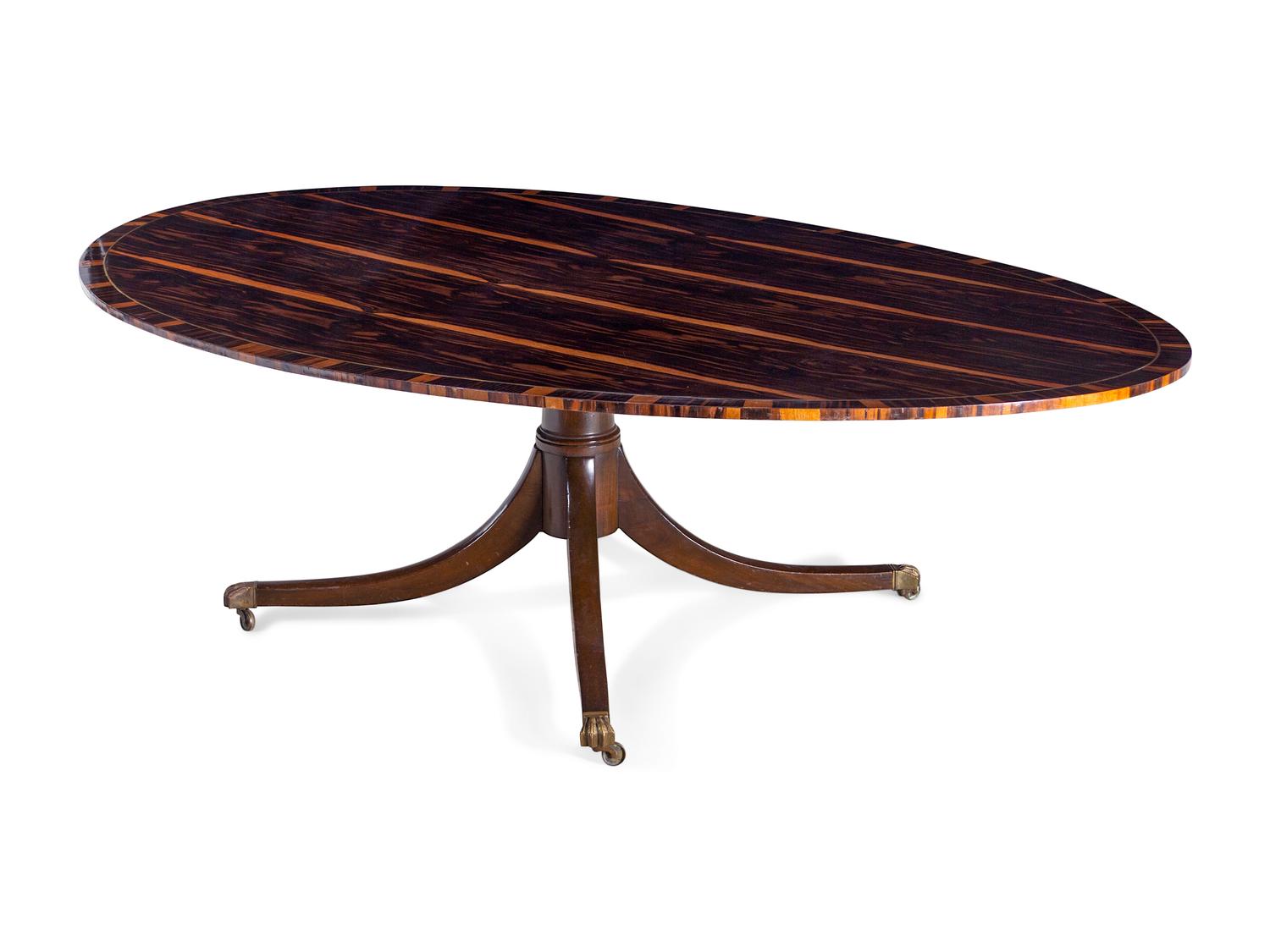 A Regency Style Macassar Ebony Oval Dining Table Top on an Associated Base