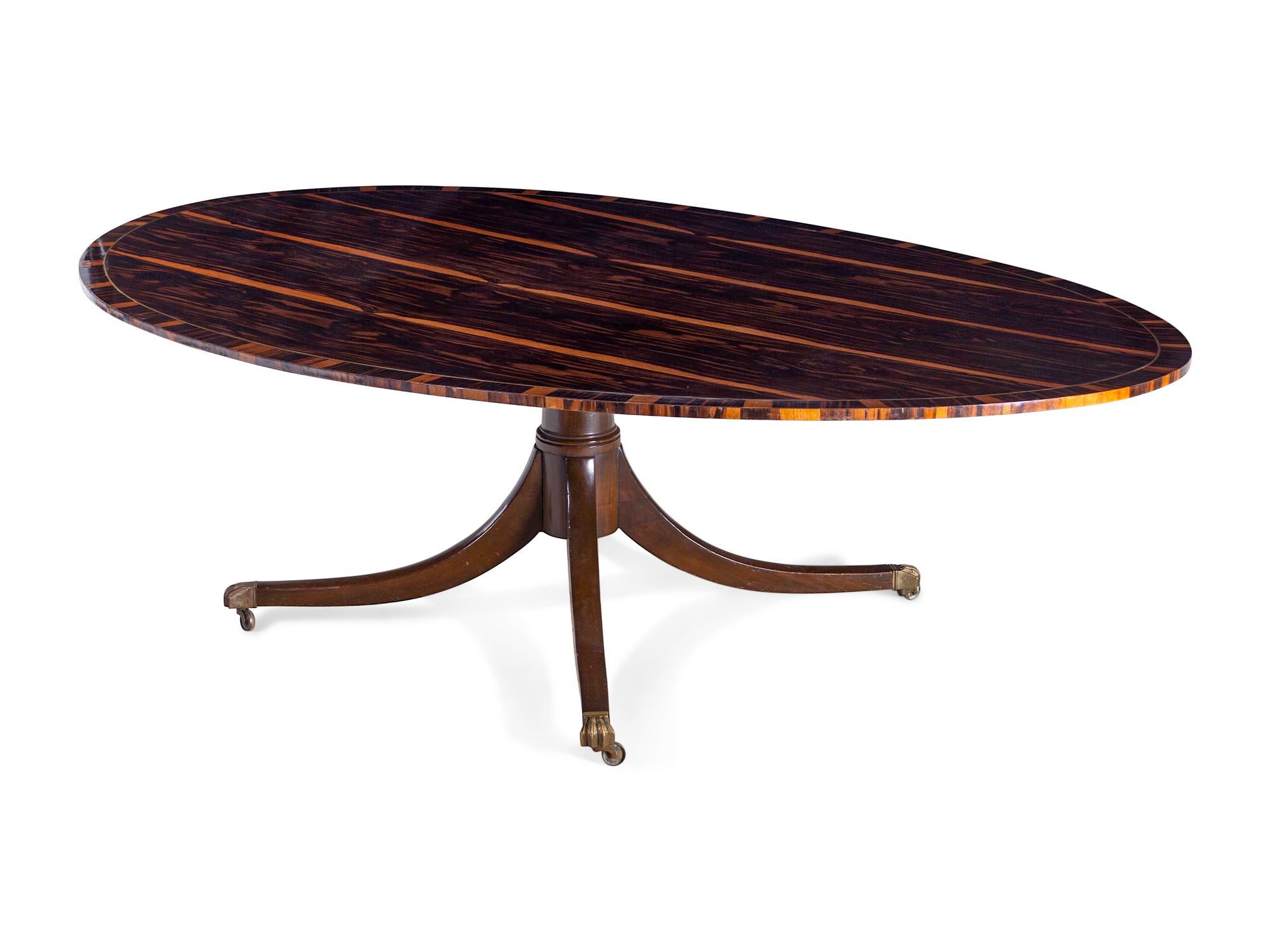 A Regency Style Macassar Ebony Oval Dining Table Top on an Associated Base