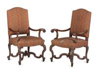A Pair of Louis XV Style Carved Walnut Fauteuils