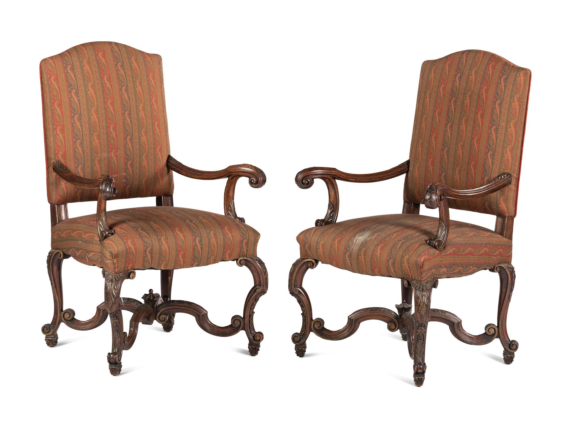 A Pair of Louis XV Style Carved Walnut Fauteuils