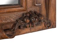 A Continental Carved Oak Mirror