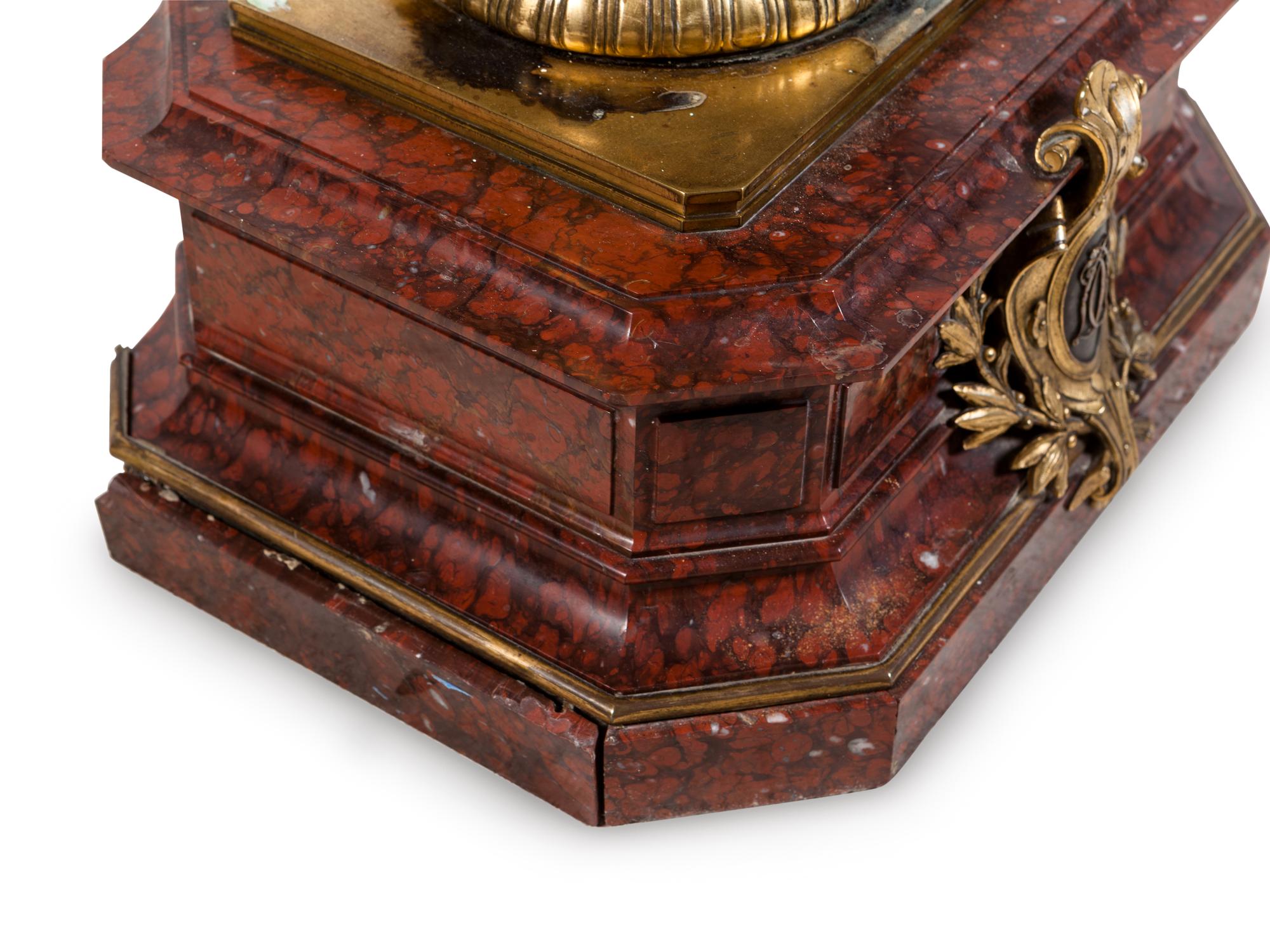 A Napoleon III Gilt and Silvered Bronze and Rouge Griotte Marble Figural Clock