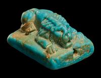 An Egyptian Faience Recumbent Lion Bead
