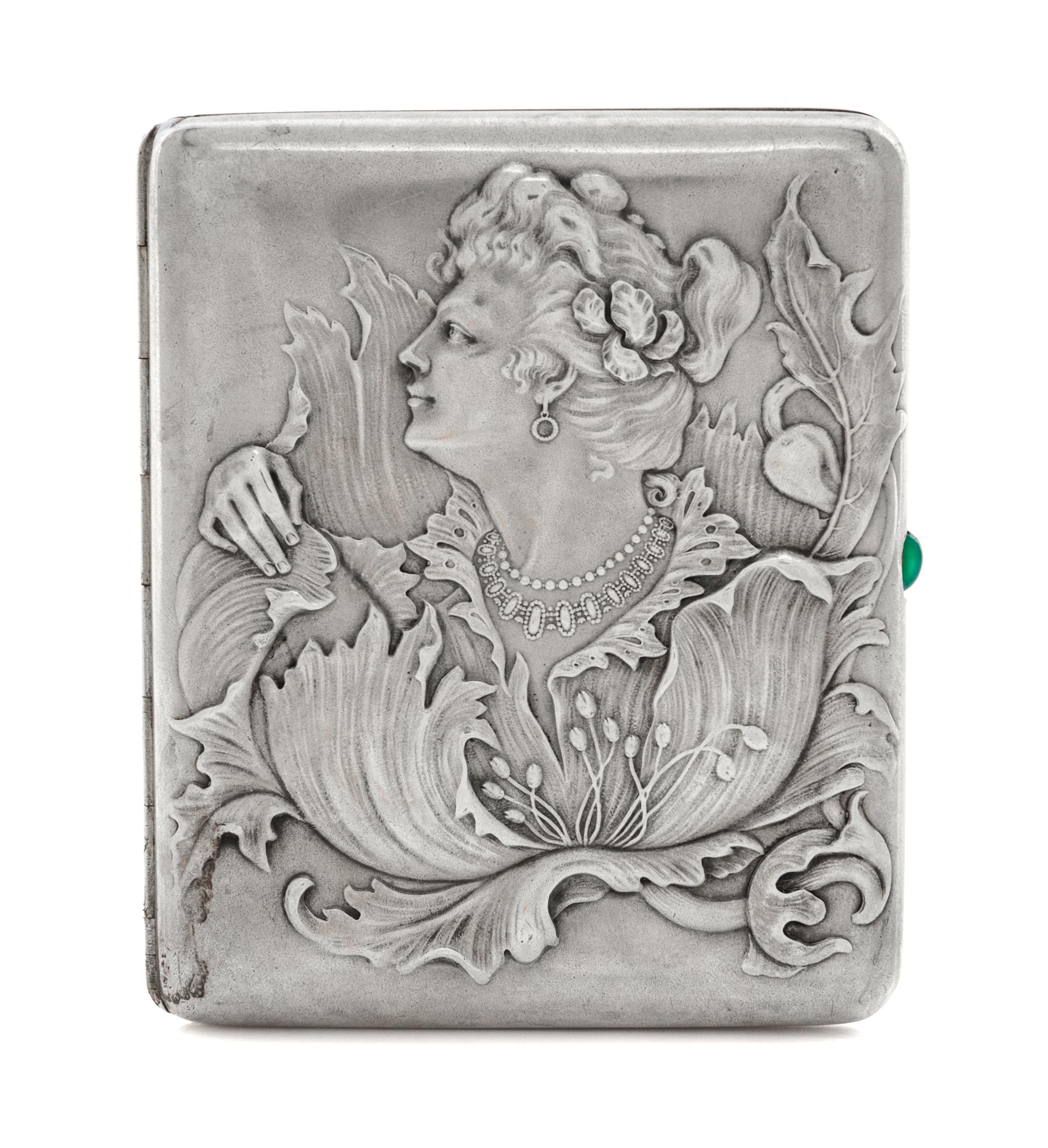 A Russian Silver Cigarette Case, Maker's mark obscured, assay mark of Ivan Lebedkin, Moscow, the lid with raised decoration showing a w