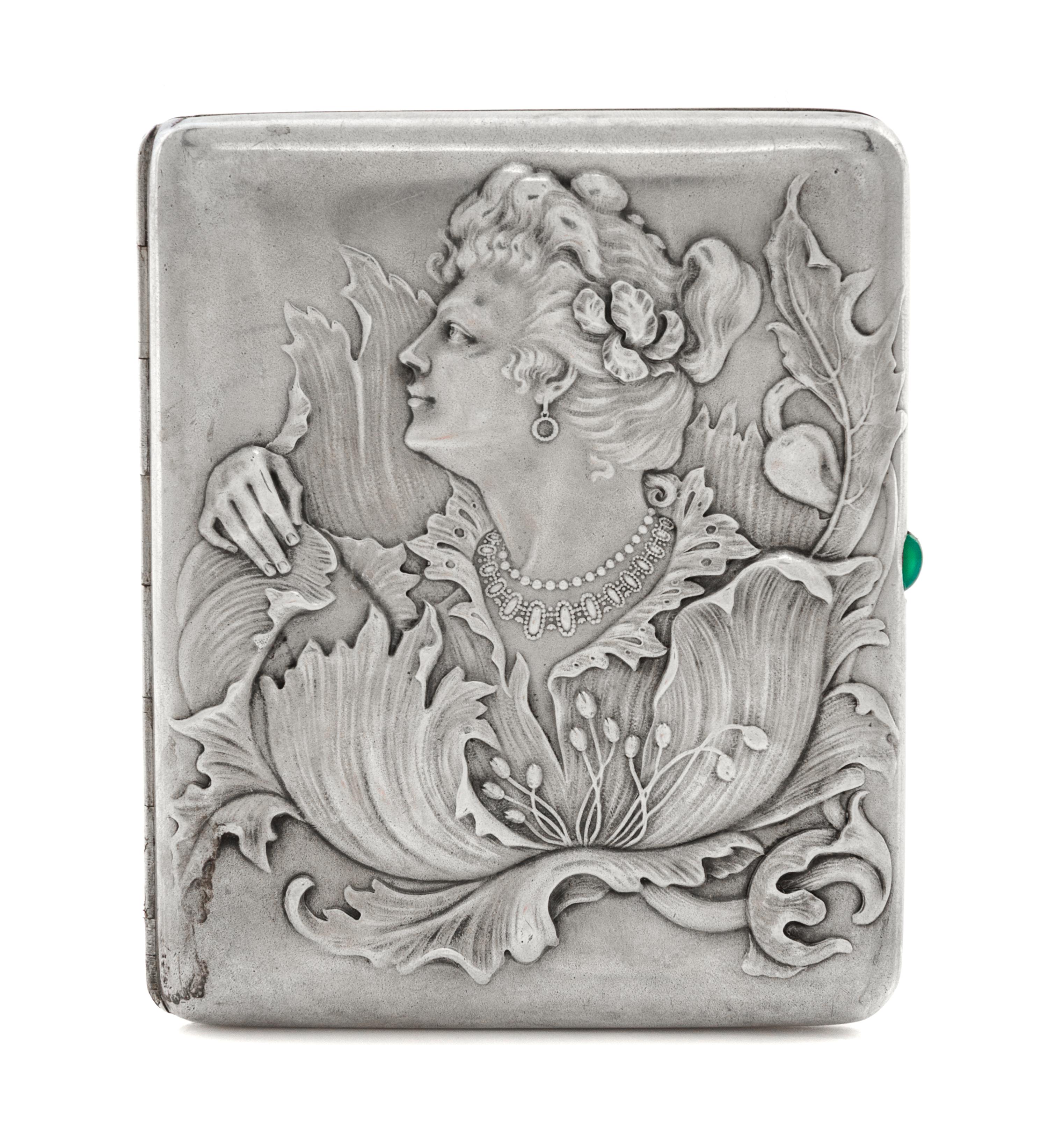 A Russian Silver Cigarette Case, Maker's mark obscured, assay mark of Ivan Lebedkin, Moscow, the lid with raised decoration showing a w