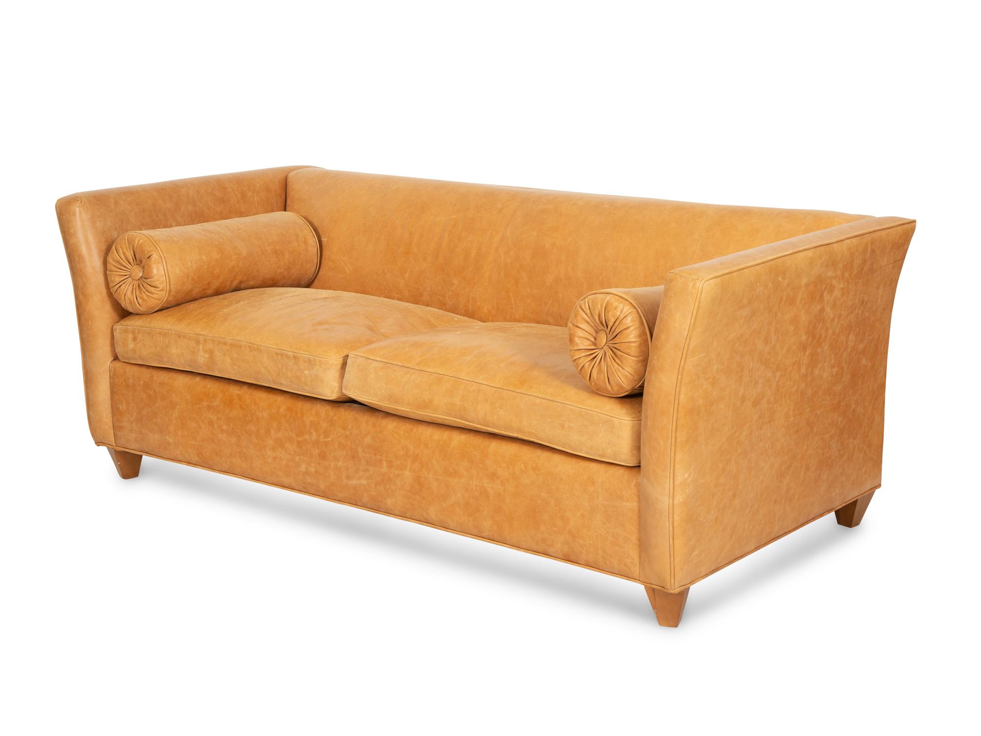 A Contemporary Leather Sofa with Two Bolster Pillows