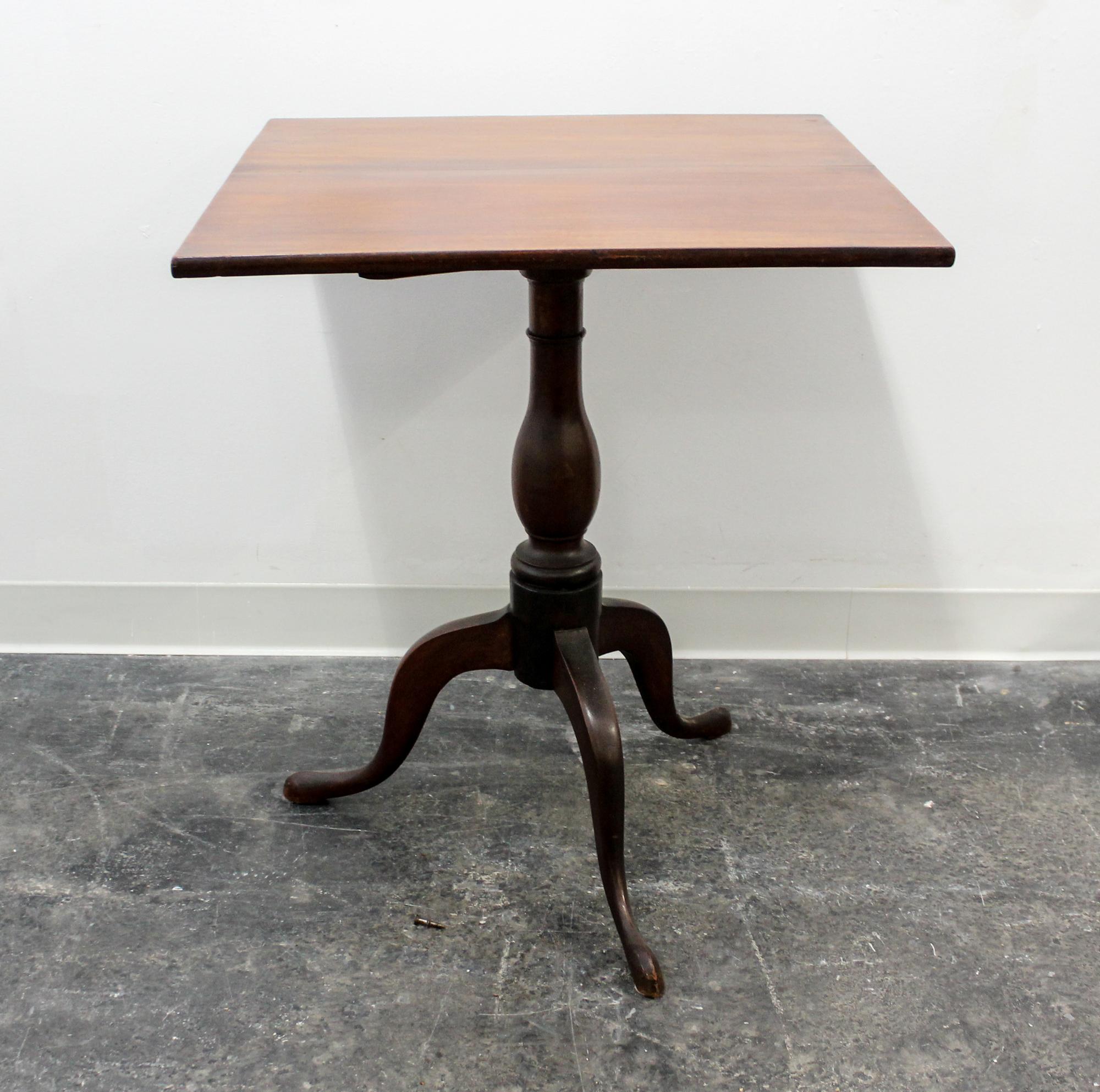 An American Walnut Tilt-top Table Height 47 inches.
