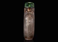 A Chinese carved smoky quartz snuff bottle and a jadeite snuff bottle 煙晶石及翡翠鼻煙壺各一只