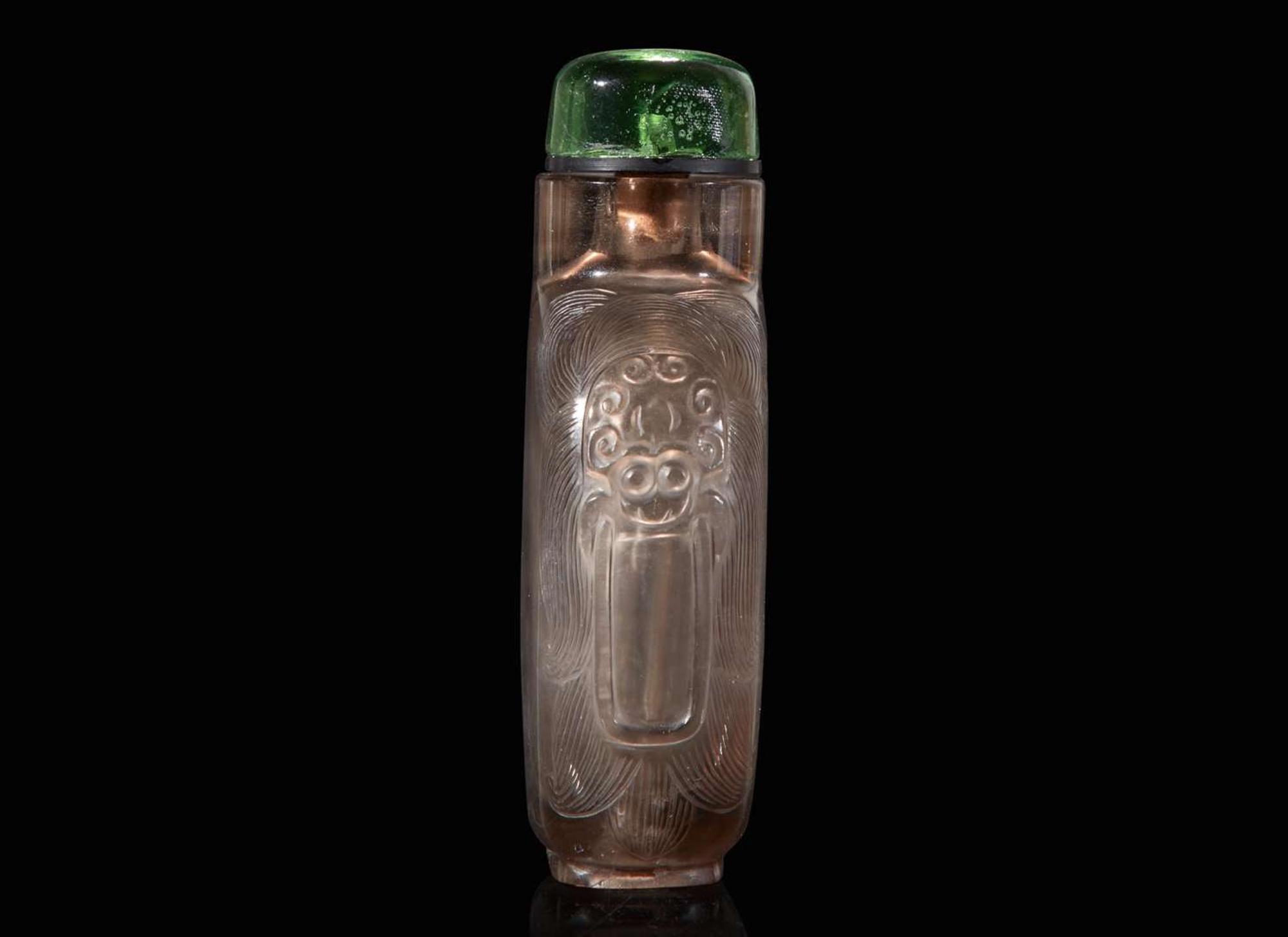 A Chinese carved smoky quartz snuff bottle and a jadeite snuff bottle 煙晶石及翡翠鼻煙壺各一只