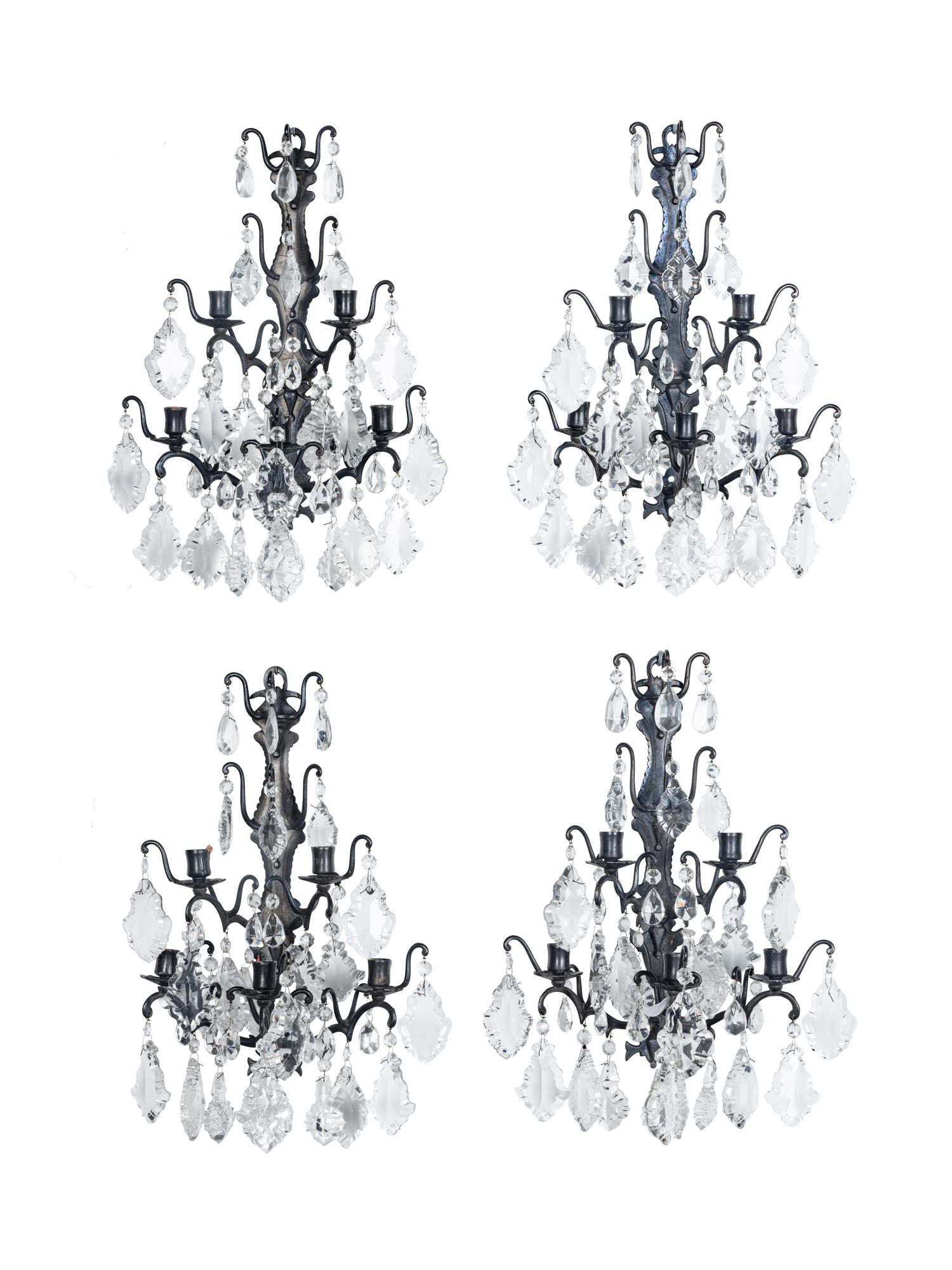 A Set of Four Iron and Glass Five-Light Sconces