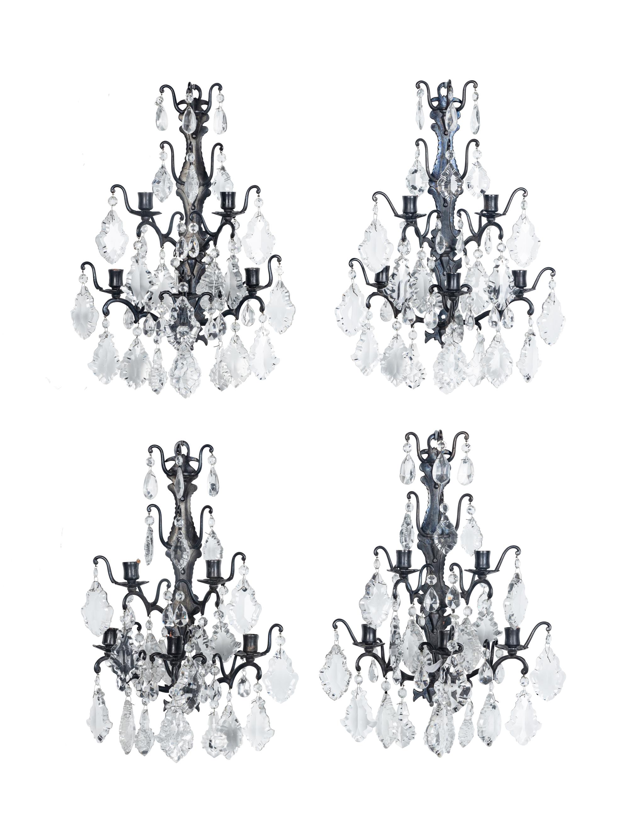 A Set of Four Iron and Glass Five-Light Sconces