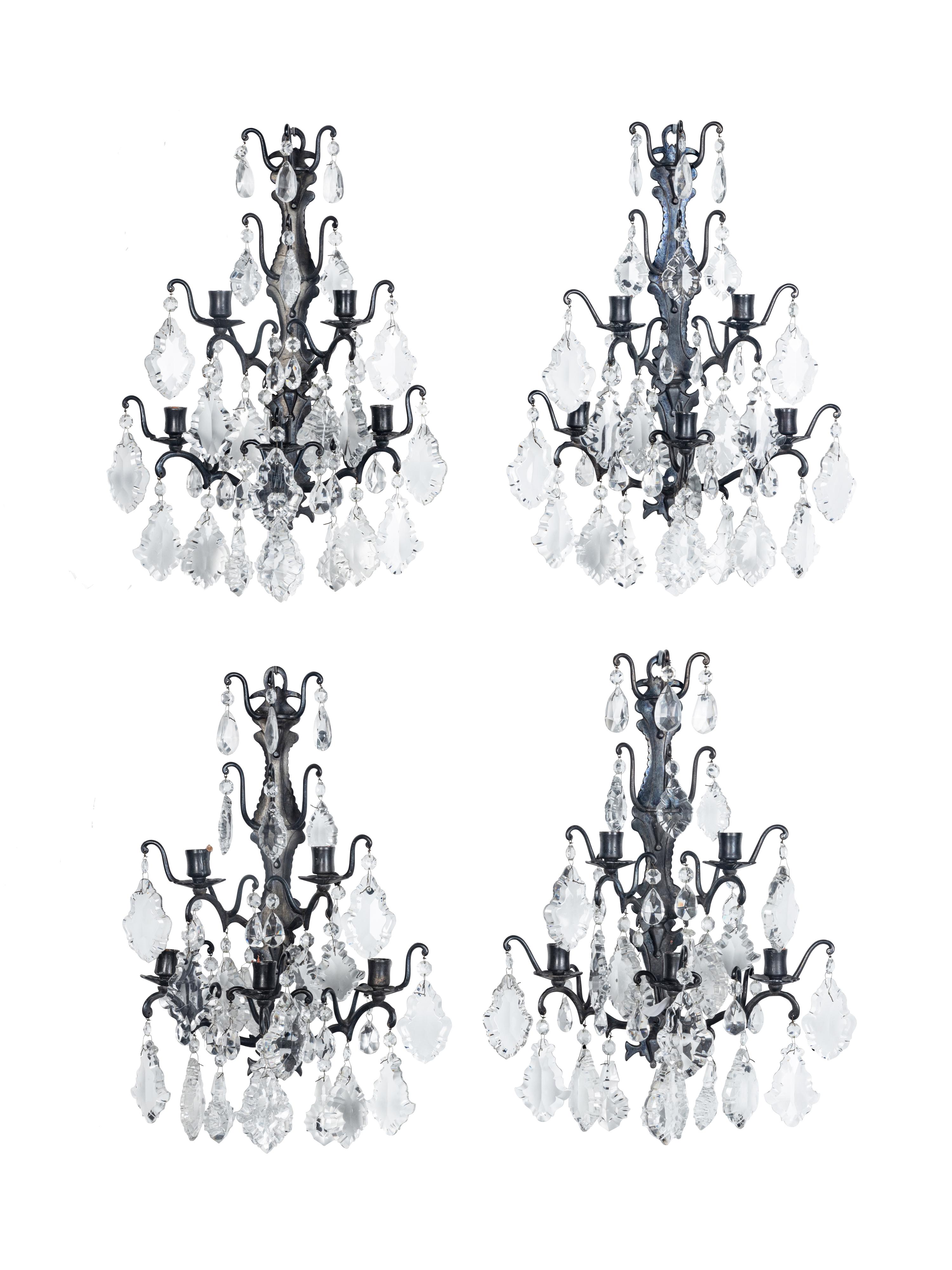 A Set of Four Iron and Glass Five-Light Sconces