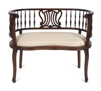 An Edwardian Mahogany Settee — EARLY 20TH CENTURY