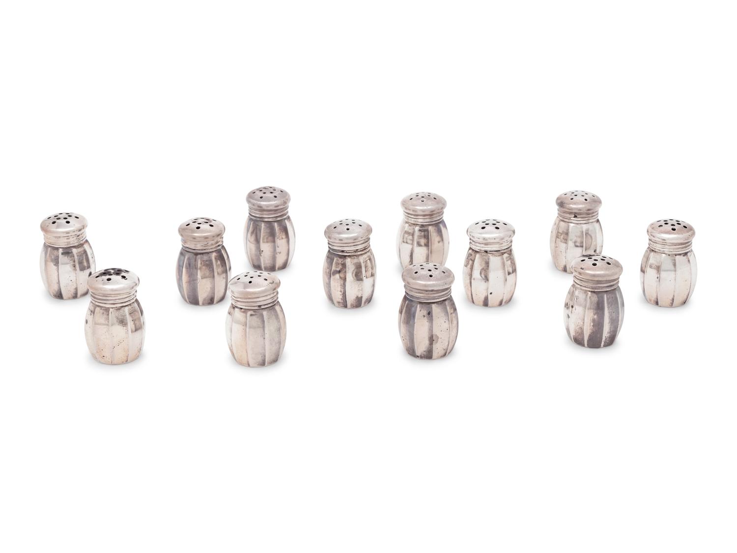 A Group of Sixteen Silver Casters
