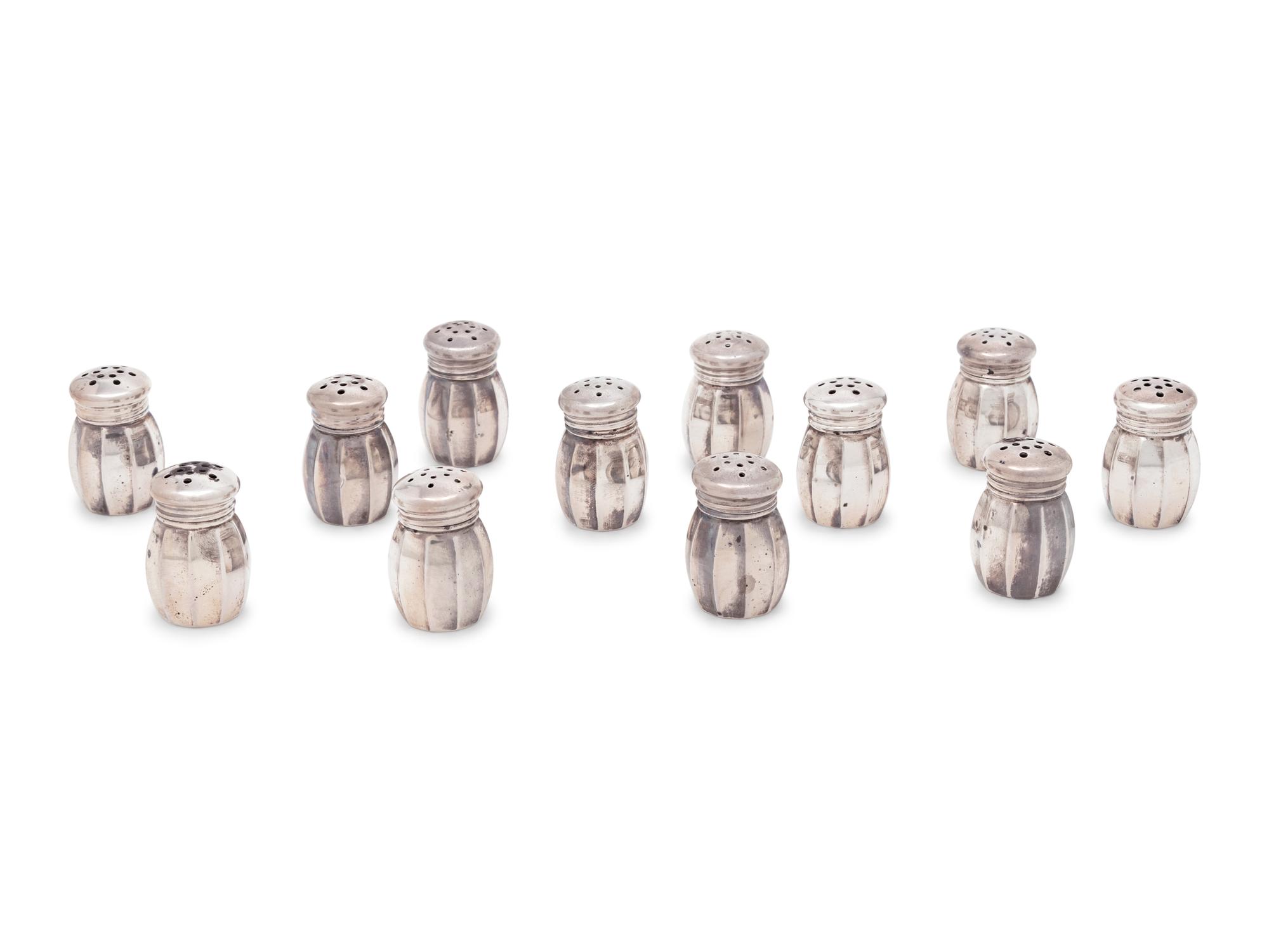 A Group of Sixteen Silver Casters