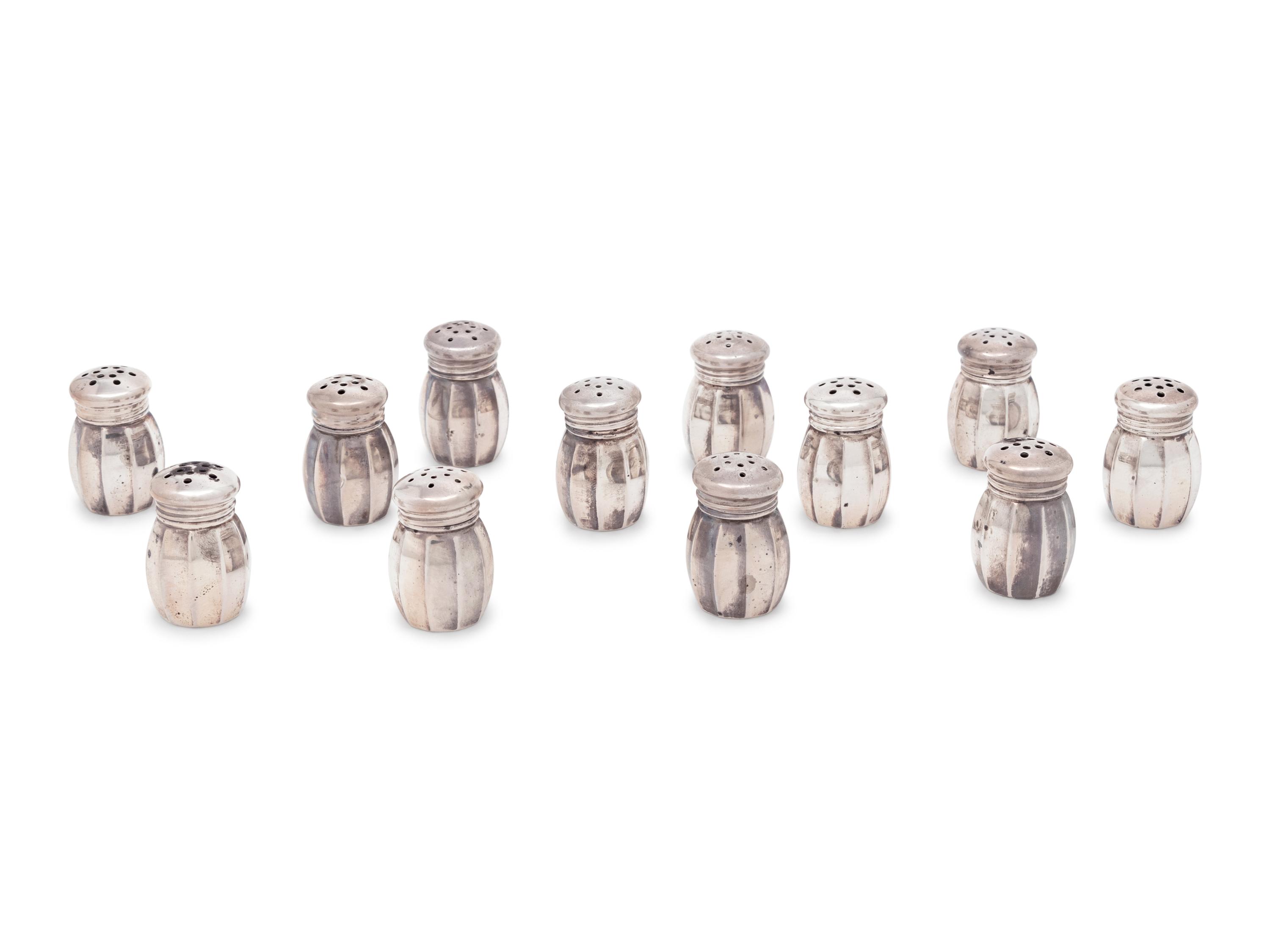 A Group of Sixteen Silver Casters