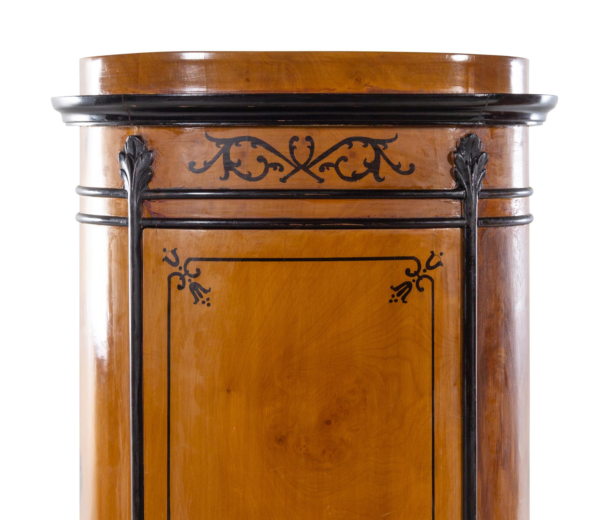 A Pair of Biedermeier Style Parcel Ebonized Satinwood Pedestal-Form Cabinets