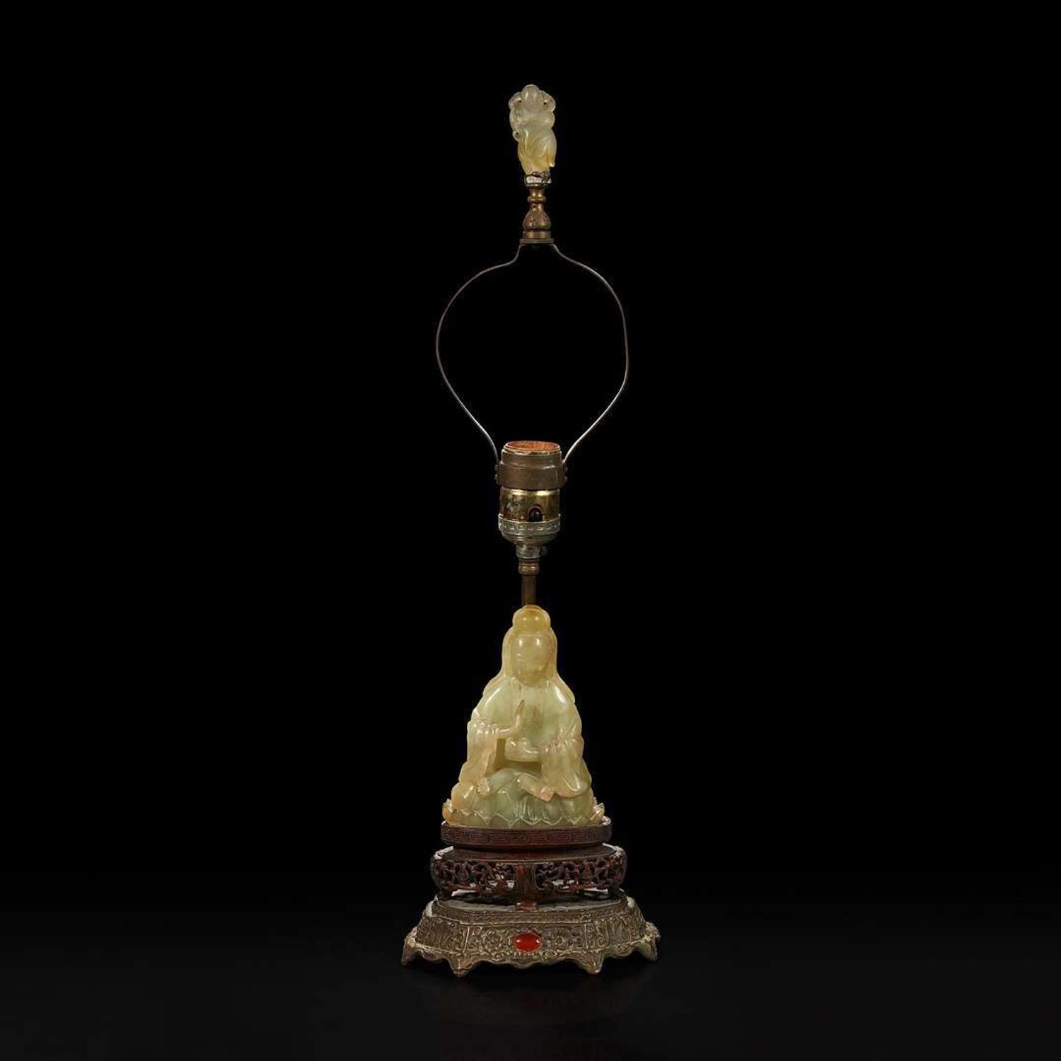 A Chinese carved mottled celadon jade figure of Guanyin, mounted as a lamp 玉雕观音改装台灯