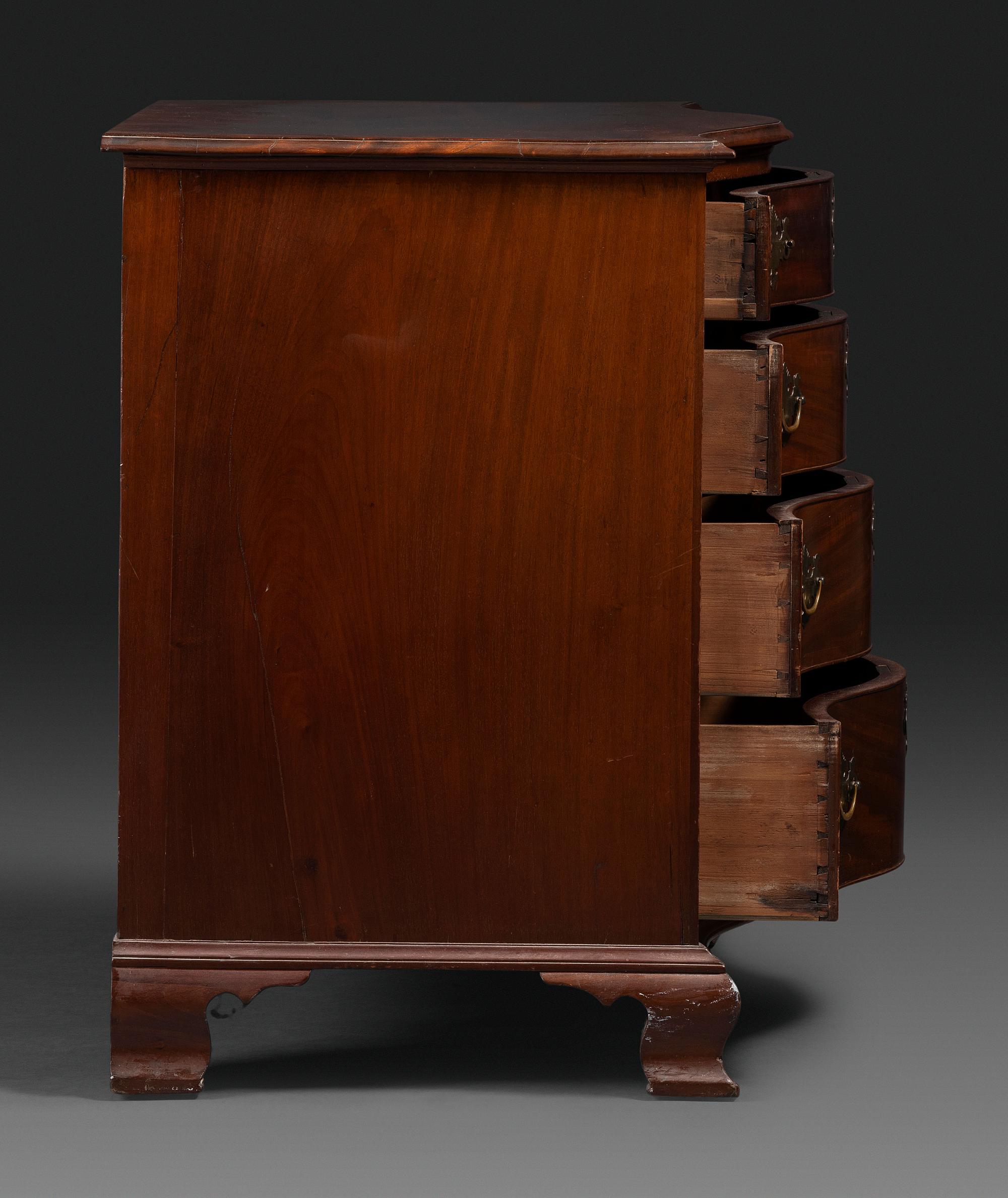 A Chippendale Figured Mahogany Serpentine Chest of Drawers