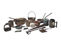 [CAMP LIFE]. A group of branding irons, utensils, and other camp tools.