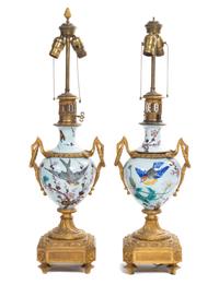 A Pair of French Gilt Bronze Mounted Ceramic Urns Height overall 31 inches.