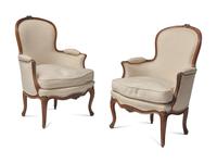 A Pair of Louis XV Carved Walnut Bergères