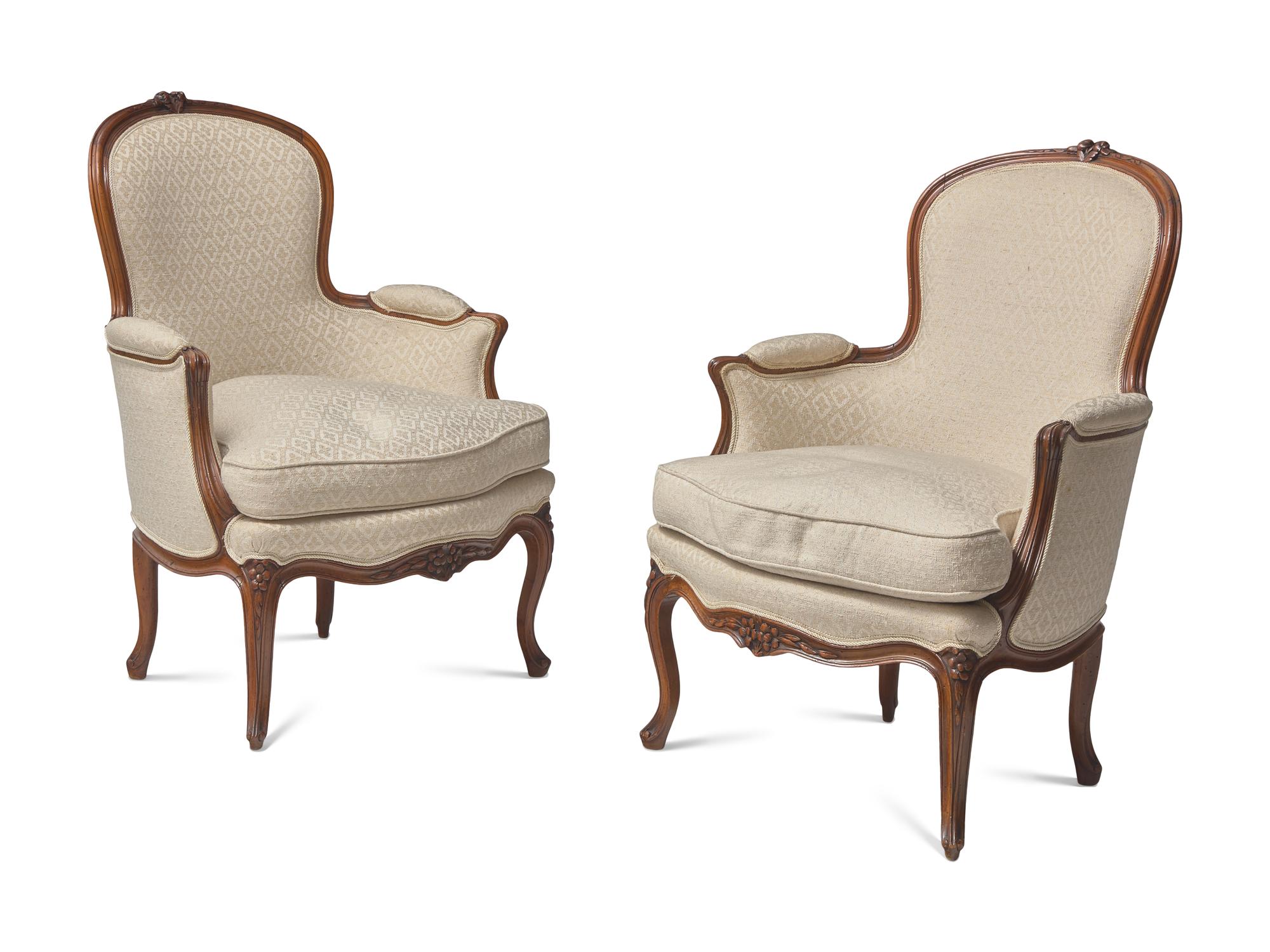 A Pair of Louis XV Carved Walnut Bergères