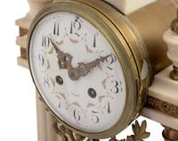 A French Gilt Metal Mounted Marble Three-Piece Clock Garniture