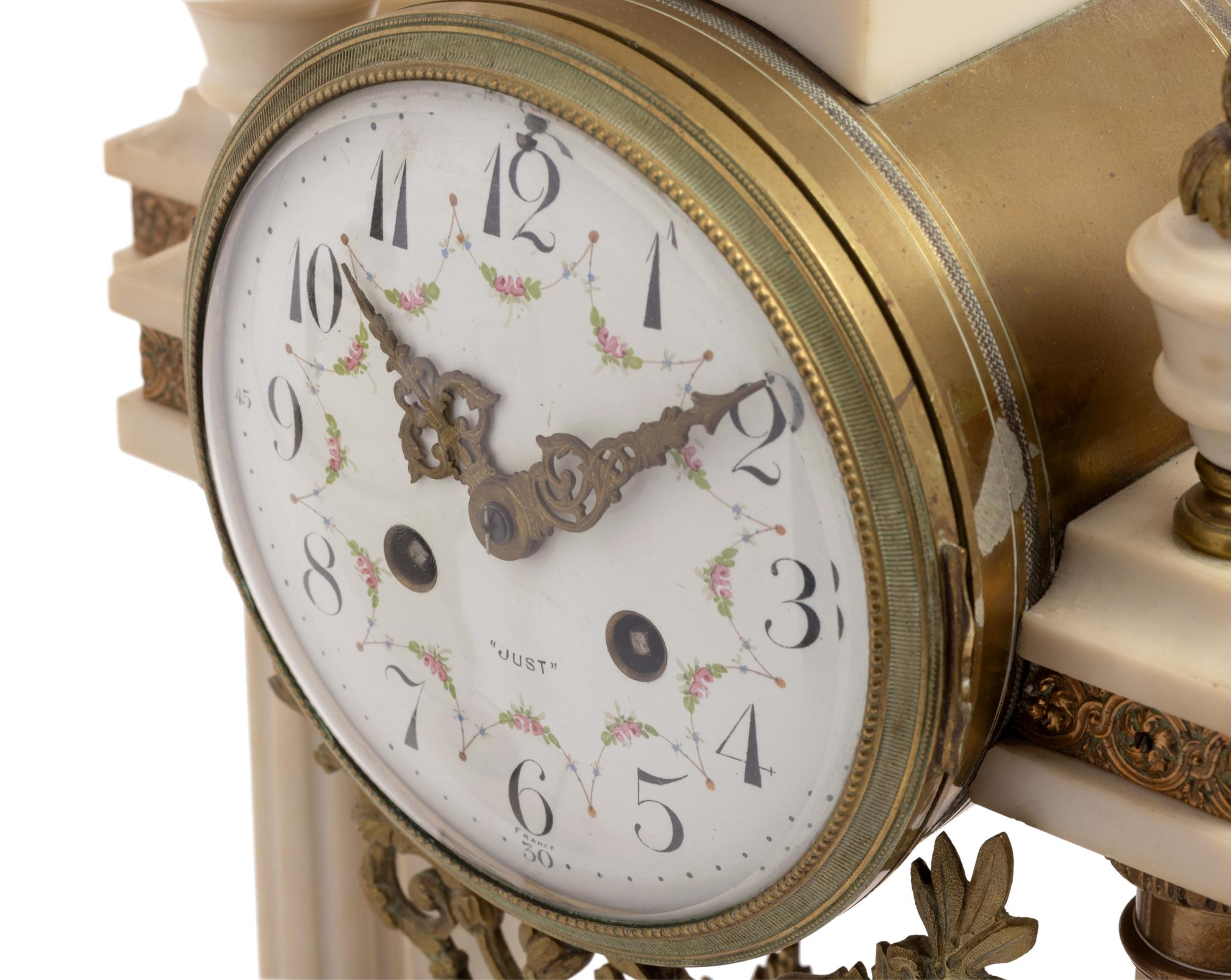 A French Gilt Metal Mounted Marble Three-Piece Clock Garniture