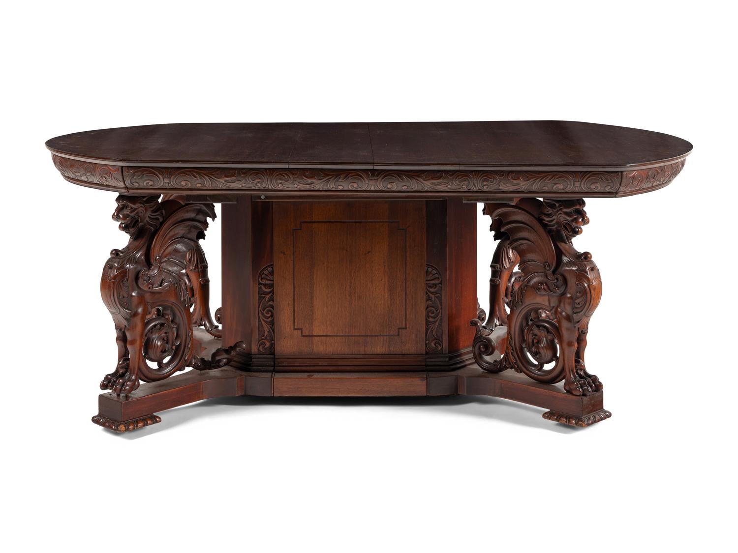A Renaissance Revival Carved Mahogany Dining Table and Set of Six Chairs