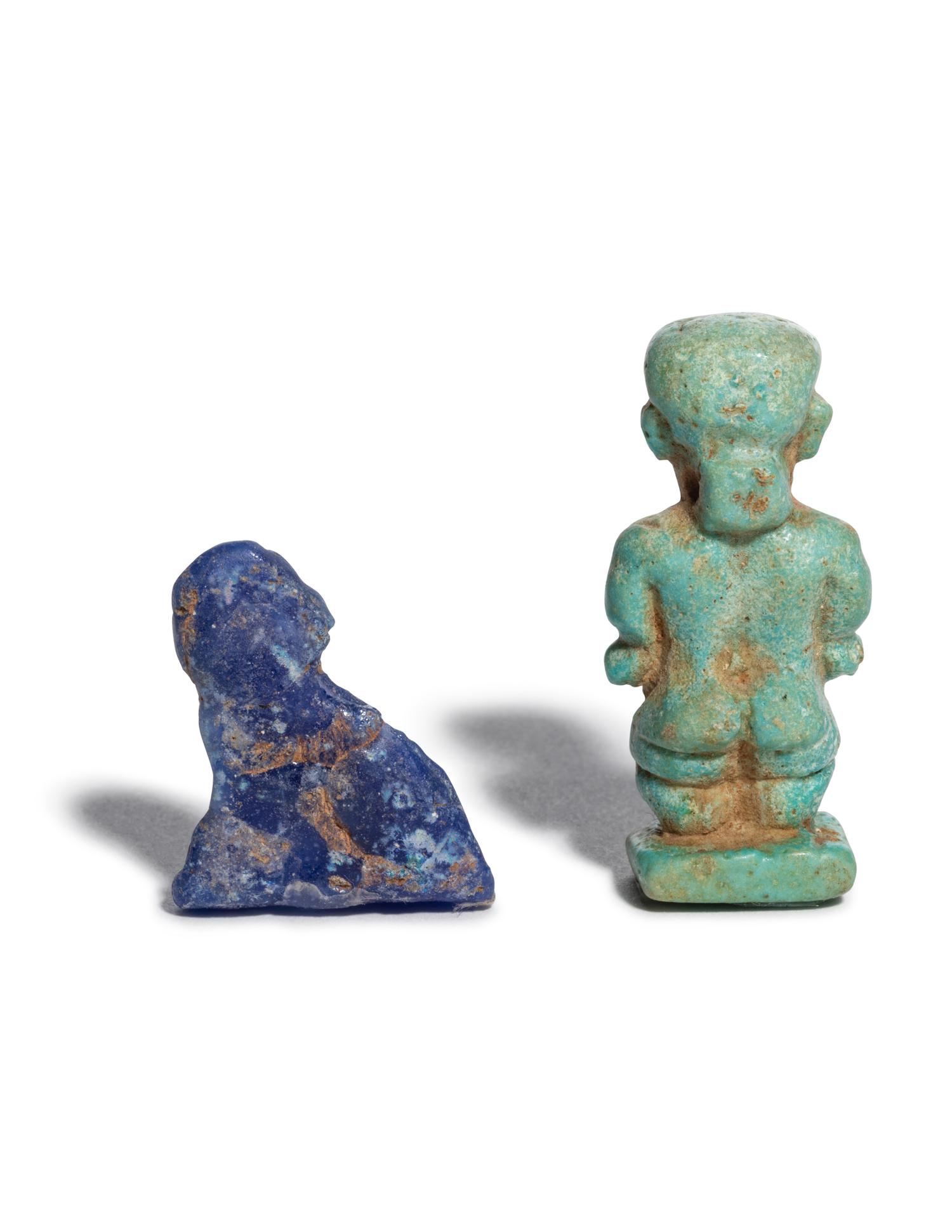 An Egyptian Glass Anubis Amulet and an Egyptian Faience Pataikos Amulet