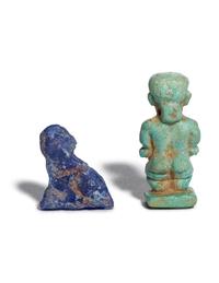 An Egyptian Glass Anubis Amulet and an Egyptian Faience Pataikos Amulet